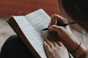 Woman writing in a notebook