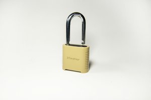 Gold padlock on a soft white surface