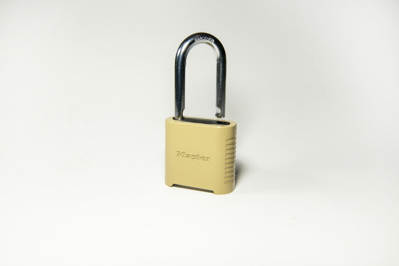 Gold padlock on a soft white surface